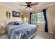 Bedroom with blue and white bedding, a ceiling fan, and natural light at 96 Grover Way, Dallas, GA 30157