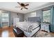 Main bedroom features a ceiling fan, hardwood floors, and ample natural light at 96 Grover Way, Dallas, GA 30157