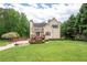 Charming two-story home with a well-manicured lawn, a cozy front porch, and mature trees at 96 Grover Way, Dallas, GA 30157