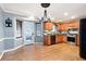 Bright eat-in kitchen features wood cabinets, stainless steel appliances, and an adjacent sunroom at 96 Grover Way, Dallas, GA 30157