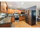 A well-equipped kitchen featuring stainless steel appliances, granite countertops, and warm wood cabinets at 96 Grover Way, Dallas, GA 30157