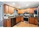 Traditional kitchen with stainless steel oven and dishwasher, wood cabinets, and granite countertops at 96 Grover Way, Dallas, GA 30157