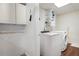 The laundry room offers a modern washer and dryer with a useful shelving unit at 96 Grover Way, Dallas, GA 30157