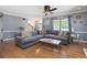 Comfortable living room features hardwood floors, a ceiling fan, and a large gray sectional sofa at 96 Grover Way, Dallas, GA 30157