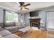 Comfortable living room featuring a cozy fireplace, ceiling fan, and natural light at 96 Grover Way, Dallas, GA 30157