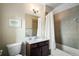 Well-lit bathroom featuring a shower-tub combo, sleek vanity, and contemporary fixtures at 1671 Hammock Dr, Smyrna, GA 30080