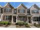 Charming townhome exterior with brick facade, shuttered windows, and well-maintained landscaping at 1671 Hammock Dr, Smyrna, GA 30080