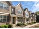 Attractive townhomes showcasing brick and siding exteriors, complemented by neat landscaping and charming details at 1671 Hammock Dr, Smyrna, GA 30080