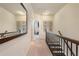 Hallway with staircase, mirror, and artwork, showing the flow of the house at 1671 Hammock Dr, Smyrna, GA 30080