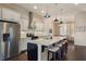 Modern kitchen with stainless steel appliances, granite countertops, and an open view of the dining area at 1671 Hammock Dr, Smyrna, GA 30080