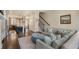 Open-concept living area with a sofa, kitchen view, and plenty of natural light at 1671 Hammock Dr, Smyrna, GA 30080