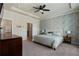 Spacious main bedroom with tray ceiling, patterned wall, and lots of natural light at 1671 Hammock Dr, Smyrna, GA 30080