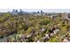 Stunning aerial view of homes surrounded by lush greenery with the city skyline in the background at 15 Northwood Ne Ave, Atlanta, GA 30309