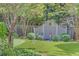 Beautiful backyard features a manicured lawn, a decorative fence, mature trees, and shrubbery at 15 Northwood Ne Ave, Atlanta, GA 30309