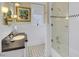 Bright bathroom with a vanity, undermount sink, patterned tile floor, and glass-enclosed shower at 15 Northwood Ne Ave, Atlanta, GA 30309
