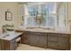 Bathroom with stylish vanity, marble countertop, undermount sink, and a large window offering natural light at 15 Northwood Ne Ave, Atlanta, GA 30309