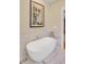 Relaxing bathroom showcasing a modern standalone tub, tiled walls, and elegant fixtures at 15 Northwood Ne Ave, Atlanta, GA 30309