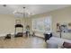 Bright exercise room features a treadmill, stationary bike, and a comfortable sofa with a wooden floor at 15 Northwood Ne Ave, Atlanta, GA 30309