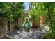 Serene backyard showcasing a large decorative pot, stone ground cover and lush foliage for a tranquil setting at 1601 Marlbrook Ne Dr, Atlanta, GA 30307