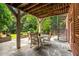 Tranquil outdoor patio featuring comfortable seating, a spiral staircase, and a beautifully landscaped garden backdrop at 1601 Marlbrook Ne Dr, Atlanta, GA 30307