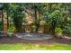 Charming backyard retreat with gravel patio, seating, potted plants, and landscaping for a relaxing ambiance at 1601 Marlbrook Ne Dr, Atlanta, GA 30307