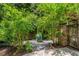 Tranquil backyard with lush greenery, vibrant pomegranate trees, and a decorative pot centerpiece at 1601 Marlbrook Ne Dr, Atlanta, GA 30307