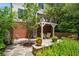 Picturesque backyard with stone patio, lush landscaping, and an elevated deck offering serene outdoor living at 1601 Marlbrook Ne Dr, Atlanta, GA 30307