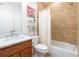 Bathroom featuring travertine tile, granite countertop, modern fixtures, and a shower-tub combination at 1601 Marlbrook Ne Dr, Atlanta, GA 30307
