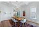 Bright dining room features wood table, modern chandelier, white walls, hardwood floors, and coffered ceilings at 1601 Marlbrook Ne Dr, Atlanta, GA 30307