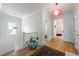 Bright hallway with hardwood floors, white walls, and stylish pink pendant lights at 1601 Marlbrook Ne Dr, Atlanta, GA 30307