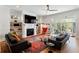 Spacious living room with hardwood floors, a fireplace, stylish furniture, and large windows at 1601 Marlbrook Ne Dr, Atlanta, GA 30307