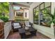Cozy porch with wicker furniture, brick flooring, and view of lush greenery at 1601 Marlbrook Ne Dr, Atlanta, GA 30307