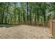 Large wooden deck with railing overlooks the wooded backyard at 535 Emerald Pkwy, Sugar Hill, GA 30518