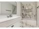 Modern bathroom with marble-style walls, a sleek vanity, and a matching framed mirror at 535 Emerald Pkwy, Sugar Hill, GA 30518
