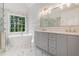 Elegant bathroom featuring a standalone tub and double vanity with a beautiful outdoor view at 535 Emerald Pkwy, Sugar Hill, GA 30518