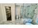 Luxurious bathroom with a glass-enclosed shower, a soaking tub, and elegant marble flooring at 535 Emerald Pkwy, Sugar Hill, GA 30518