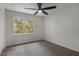 Simple bedroom with neutral carpet, ceiling fan, and natural light from a window at 535 Emerald Pkwy, Sugar Hill, GA 30518