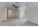 Well lit bedroom with neutral carpet, ceiling fan, and a large window for natural light at 535 Emerald Pkwy, Sugar Hill, GA 30518