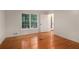 Bedroom featuring wood floors and windows with green outdoor views at 535 Emerald Pkwy, Sugar Hill, GA 30518