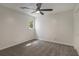 Cozy bedroom with gray carpet, a ceiling fan, and a window, offering a comfortable and inviting space at 535 Emerald Pkwy, Sugar Hill, GA 30518