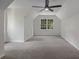Well-lit bedroom showcasing a sloped ceiling, a ceiling fan, and a window with a green outdoor view at 535 Emerald Pkwy, Sugar Hill, GA 30518
