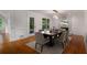 Formal dining room with a large table, modern chairs, wood floors, and a decorative fireplace at 535 Emerald Pkwy, Sugar Hill, GA 30518