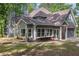 Back of the gray home showcasing a deck, screened porch, large windows, and a two-car garage at 535 Emerald Pkwy, Sugar Hill, GA 30518