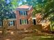 Traditional brick home with black shutters and mature trees surrounding the property at 535 Emerald Pkwy, Sugar Hill, GA 30518