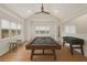 Entertain in the large game room featuring a pool table and foosball table under a ceiling fan at 535 Emerald Pkwy, Sugar Hill, GA 30518