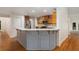 Kitchen bar with stainless steel appliances in adjoining room at 535 Emerald Pkwy, Sugar Hill, GA 30518