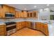 Kitchen area with stainless steel appliances, granite countertops, and light wood cabinetry at 535 Emerald Pkwy, Sugar Hill, GA 30518