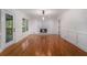 Bright living room featuring hardwood floors, fireplace, and door to back porch at 535 Emerald Pkwy, Sugar Hill, GA 30518