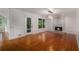 Spacious living room with wood floors, white walls, and modern fireplace at 535 Emerald Pkwy, Sugar Hill, GA 30518