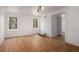 Bright living room with hardwood floors, modern lighting, and large windows with a nature view at 535 Emerald Pkwy, Sugar Hill, GA 30518